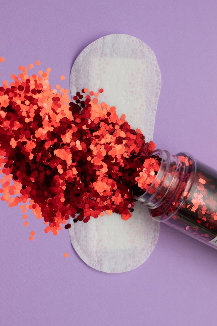 services-01 Artistic take on feminine hygiene featuring a sanitary pad and glitters on purple backdrop.